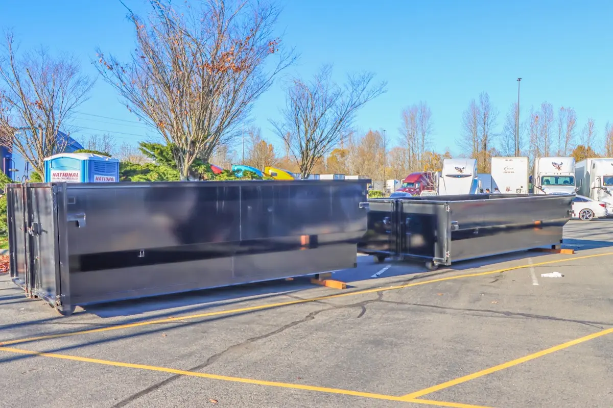 Professional dumpster rental service with roll-off container on residential driveway in Pontiac